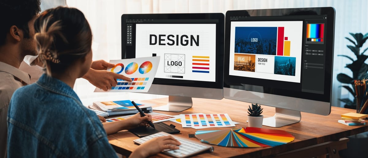 Graphic designer work on computer laptop and with graphic drawing pen while brainstorming unique design with professional graphic team in modern digital studio workplace